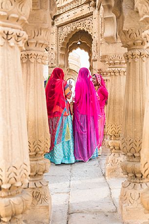 Group of Rajasthani women dressed in colorful ceremony sari at Bada Bagh complex, Jaisalmer, Rajasthan, India