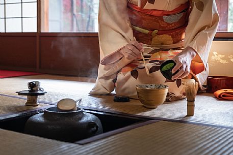 Detail of woman with kimono preparing tea during a japanese tea ceremony, Kyoto, Japan