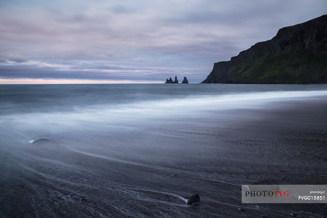 The black and mysterious beach of Vik, dominated by the stacks of Reynisdrangar