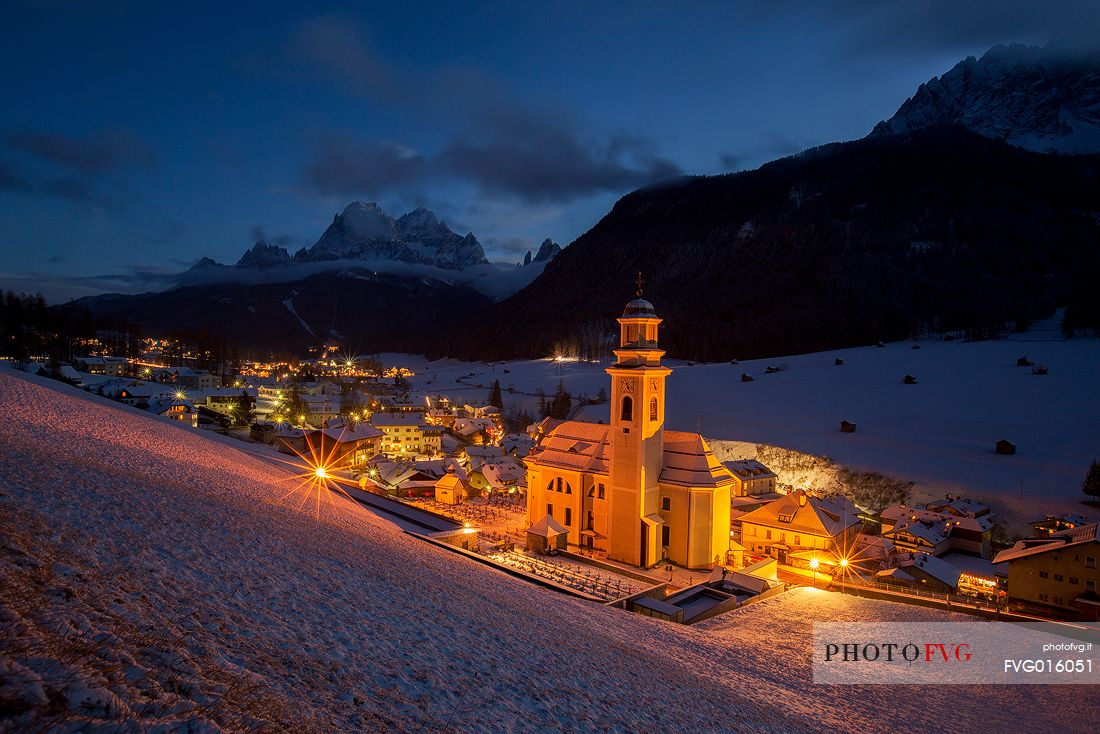 The village of Sesto in Pustertal with the Parish Church and the Sesto's sundial on background by night