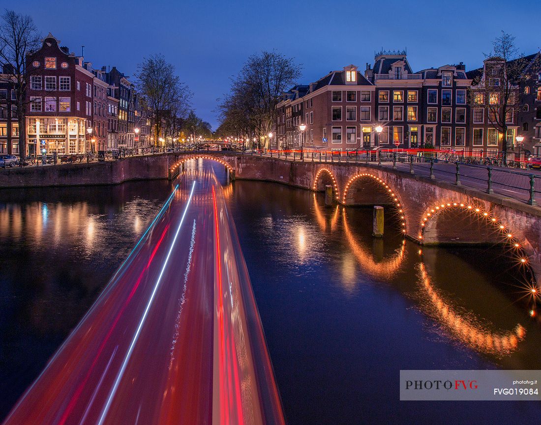 Light trails from a boat along the Keisersgracht channel , one of the three main canals of Amsterdam