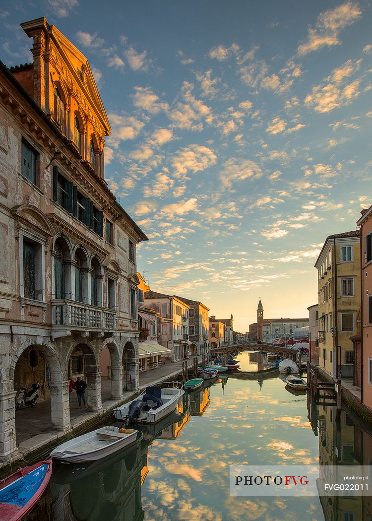 Canal Vena with the Palace Lisatti-Mascheroni in the foreground and the St. James church tower in the background at sunset, Chioggia, Venetian lagoon, Italy