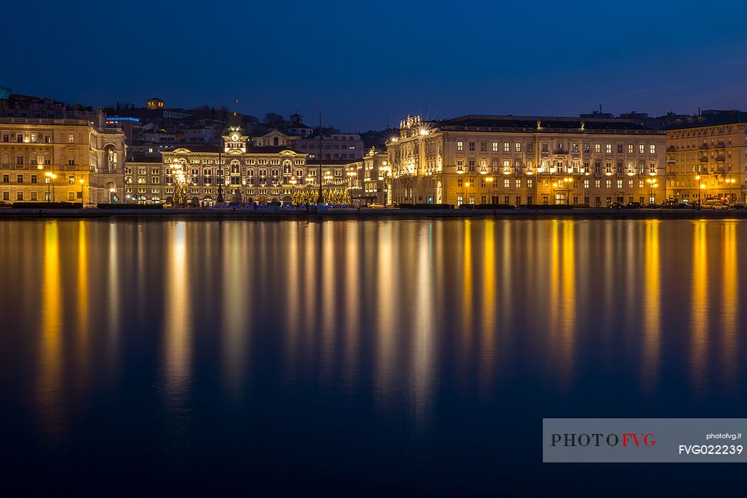 Buildings and Government palace on the waterfront of Trieste at night at Christmas time, Italy

