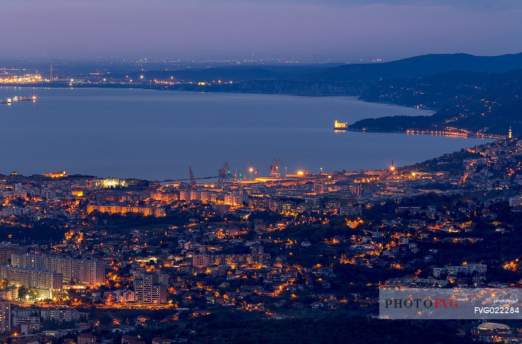 View from above of Trieste and Miramare castle at twilight, Italy