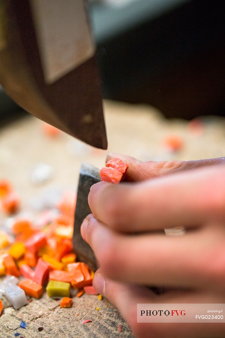 Preparing of the colored mosaic tiles and hammer in the oldest Mosaic School of Friuli, Spilimbergo, Italy