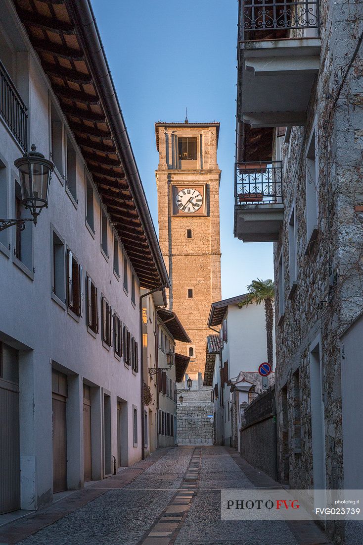 The sixteenth-century bell tower of San Daniele del Friuli lit at sunset, Italy