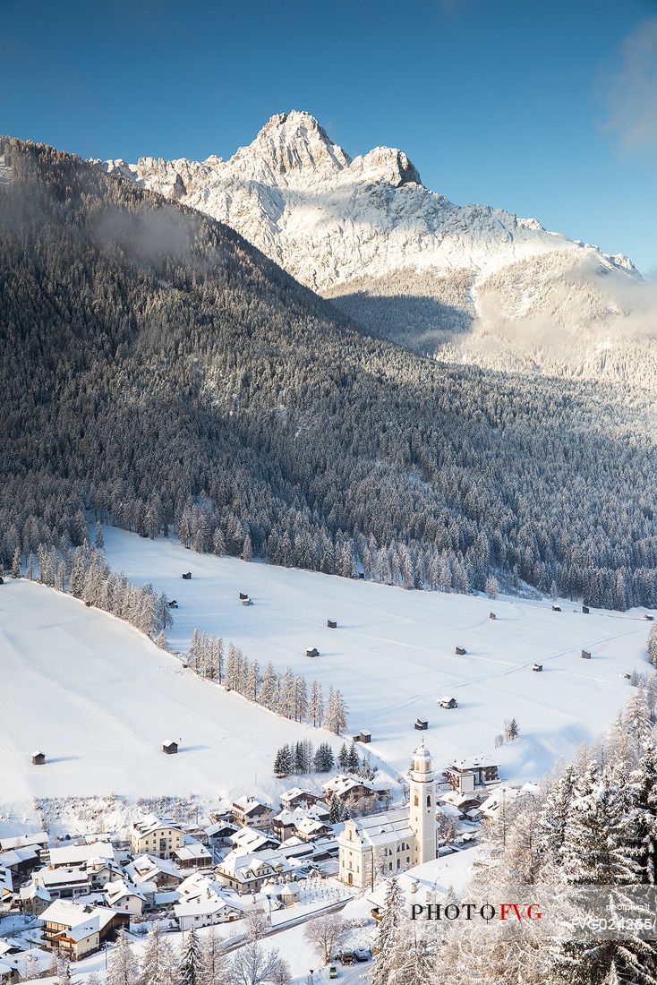 Sesto village from above and the Tre Scarpieri Mount on background in winter time, Pusteria valley, Italy