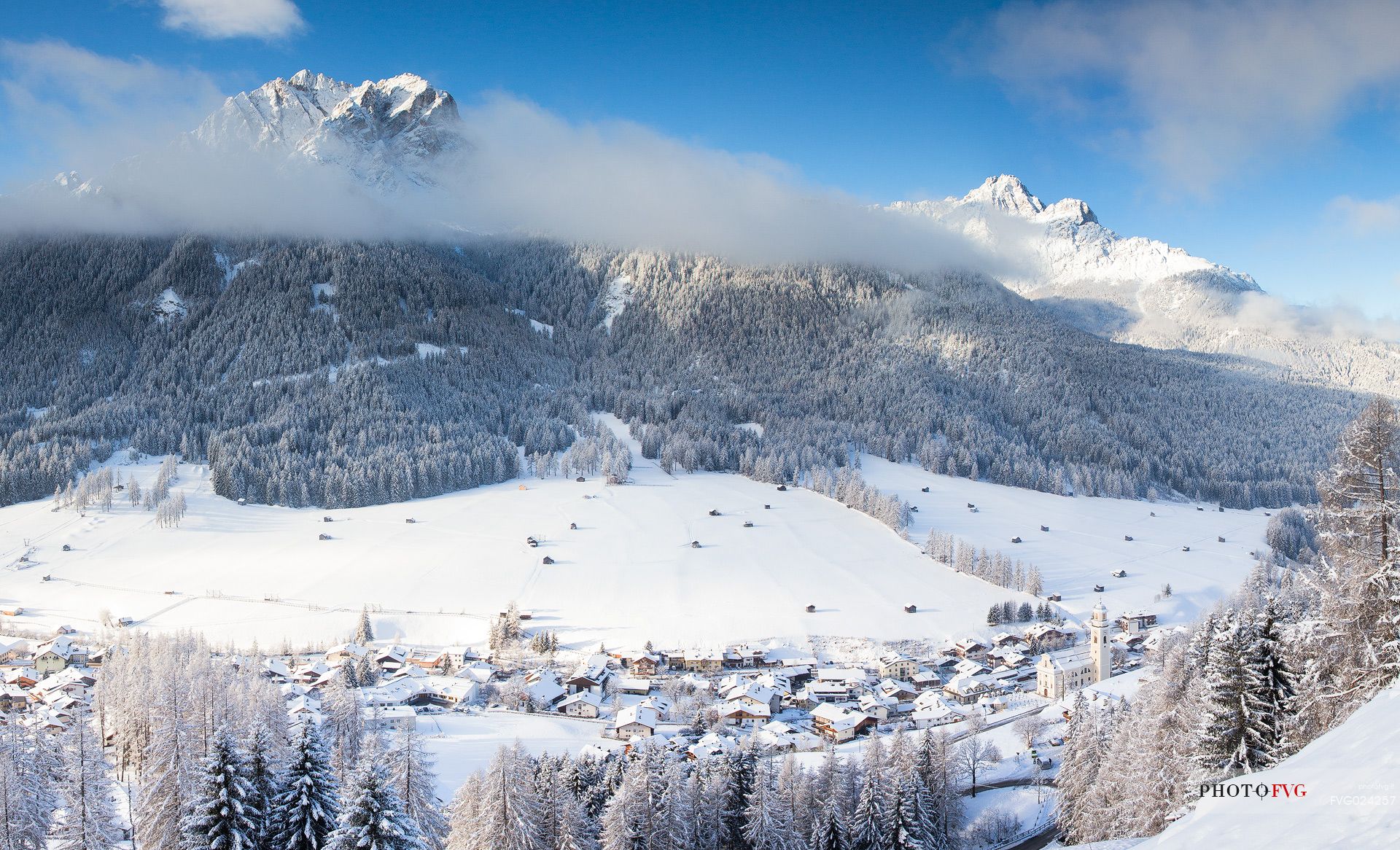 Sesto village and the Sesto dolomites in the background after a snowfall, Pusteria valley, Italy