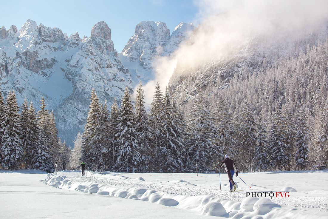 Cross country skiing in Dobbiaco Cortina trail, in the background the Piz Popena and Cristallo Mount, Landro valley, dolomites, Italia