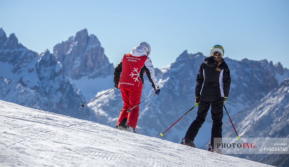 Skiers on Mount Elmo, in the background the Croda Dei Toni in the 
dolomites of Sesto natural park, Pusteria valley, Italy