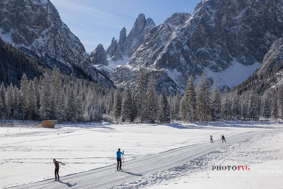 Ski cross immersed in the winter landscape of Tre Cime di Lavaredo Natural Park, Sesto, dolomites, italy