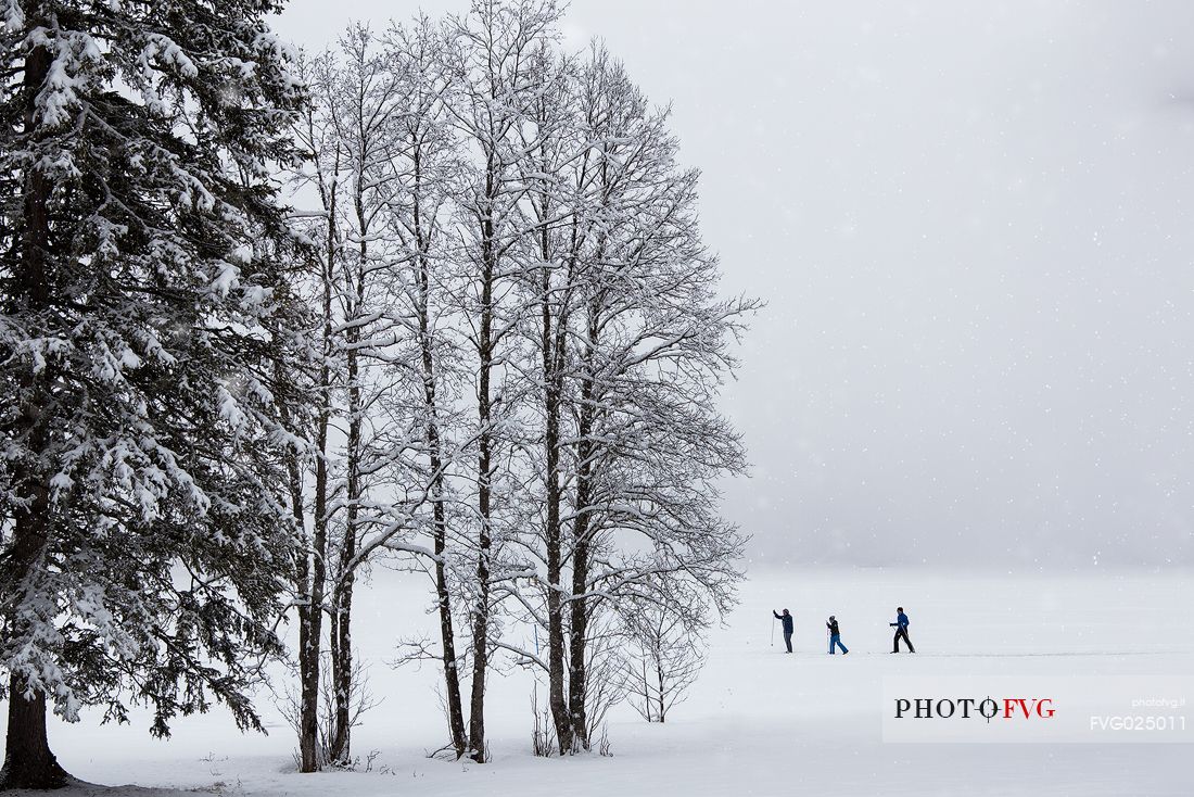 Cross country skiing on the Anterselva lake under an intensive snowfall, Pusteria Valley, Italy