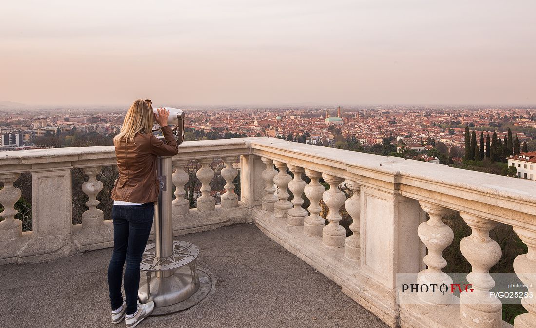 Tourist admires the city of Vicenza from the square of the Basilica of Monte Berico, Vicenza, Italy