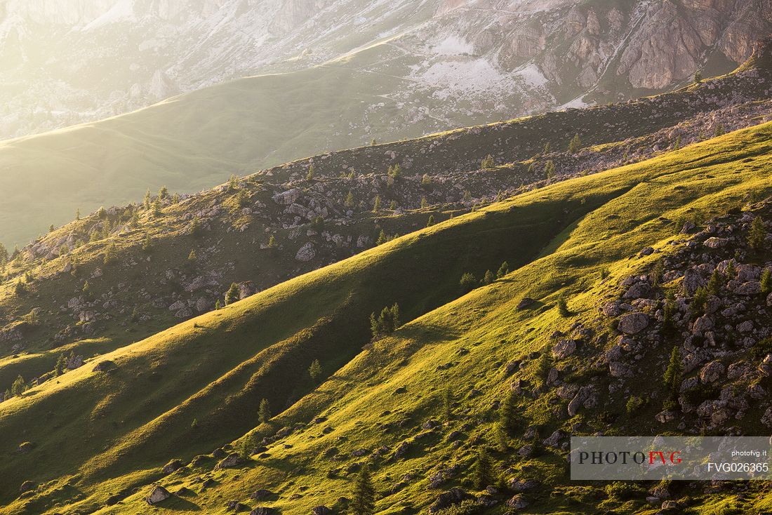 Golden hour of sunset on the meadows of Giau Pass, dolomites, Italy