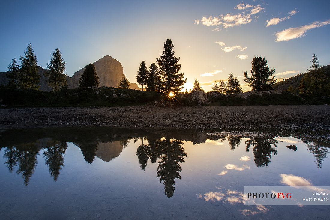 The Tofana di Rozes reflected on the little pond of Limedes during a sunrise, Cortina D'Ampezzo, Dolomites, Italy