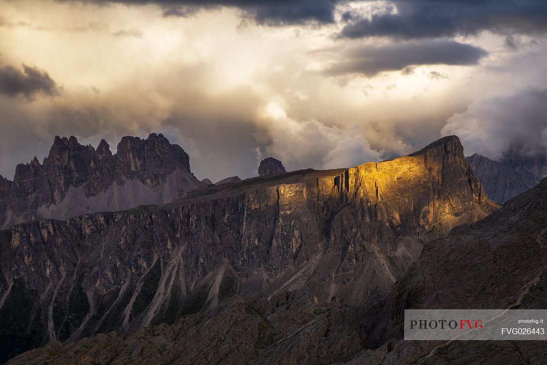 Last ray of light on Lastoi De Formin before a thunderstorm, on background the Croda Da Lago, Dolomites, Cortina D'Ampezzo, Italy