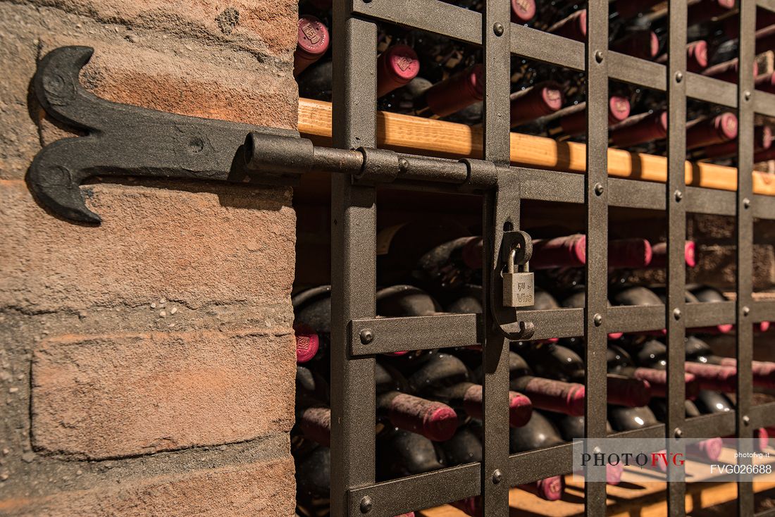 Bottles of wine in the the historic aging cellar of Castello di Spessa in Capriva del Friuli, Friuli Venezia Giulia, Italy