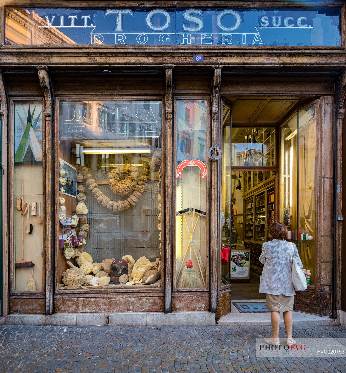 The exterior facade of the historic Toso grocery store, dating back to 1906 with marine sponges, vintage billboards and an old diving equipment featured in the showcase, Trieste, Friuli Venezia Giulia, Italy