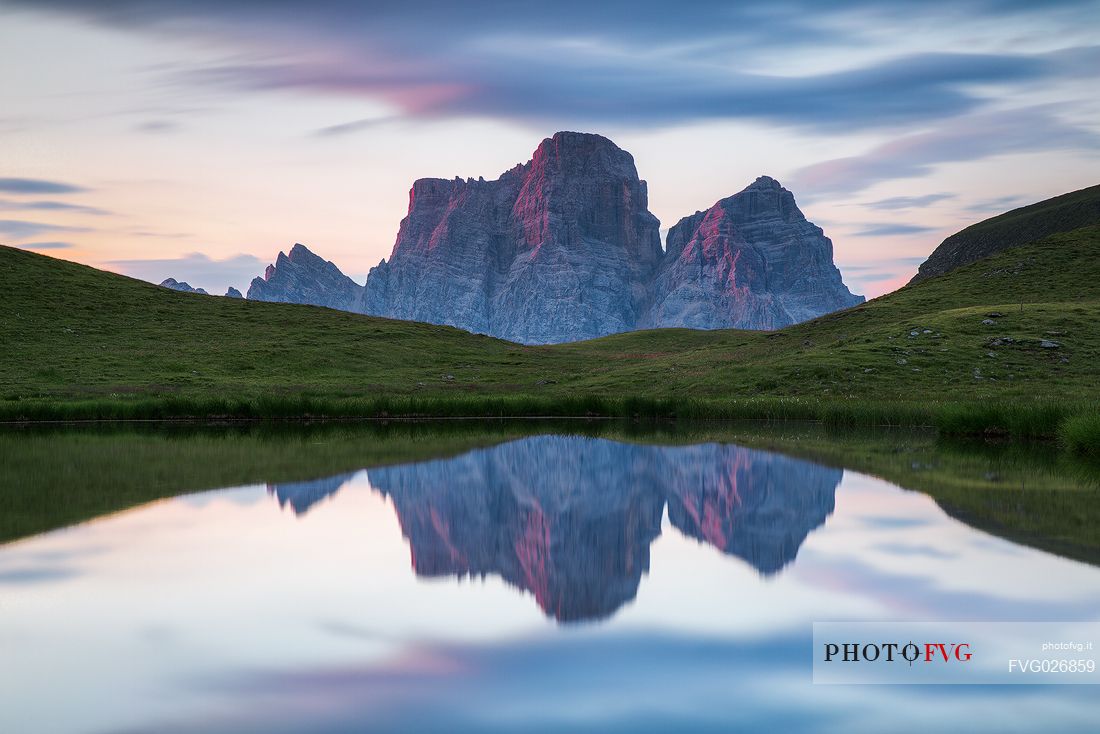 Pelmo mount reflected on Baste lake at twilight, Mondeval, Dolomites, Italy