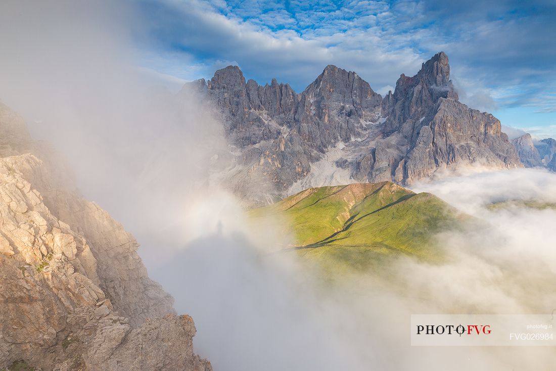 The northern chain of the Pale di San Martino over a cloud of clouds photographed from the top of the path of Cristo Pensante, Dolomites, San Martino di Castrozza, Italy