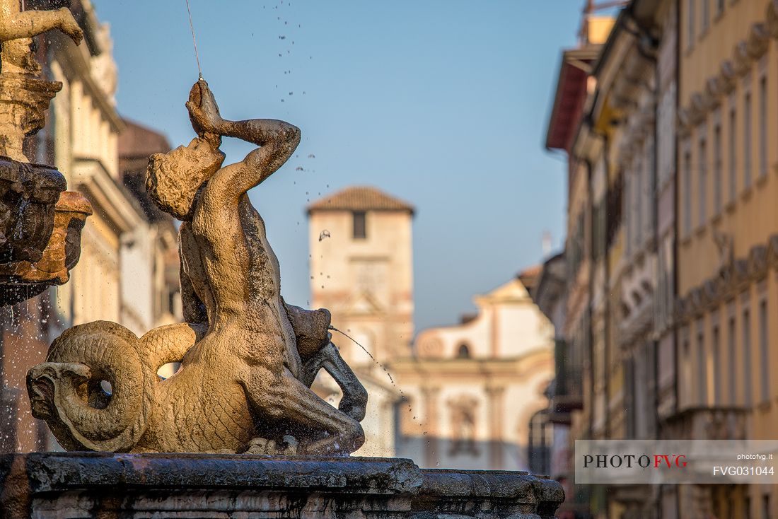 Detail of the fountain of Nettuno, on background the church of San Francesco Saverio, Trento, Trentino Alto Adige, Italy