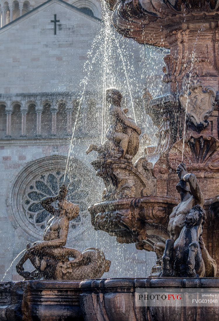 Detail of the Neptune fountain  and in the background the Cathedral of San Vigilio in Duomo square, Trento, Trentino Alto Adige, Italy