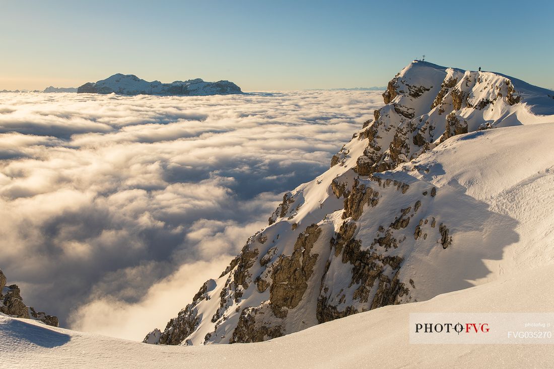 Lagazuoi peak and sea of clouds at sunset from the Lagazuoi refuge, in the background the Sella mountain range, dolomites, Italy, Europe
