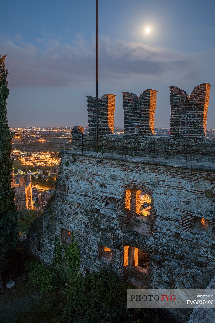 The towers of the Castello Superiore of Marostica by night and in the background the old town, Vicenza, Veneto, Italy