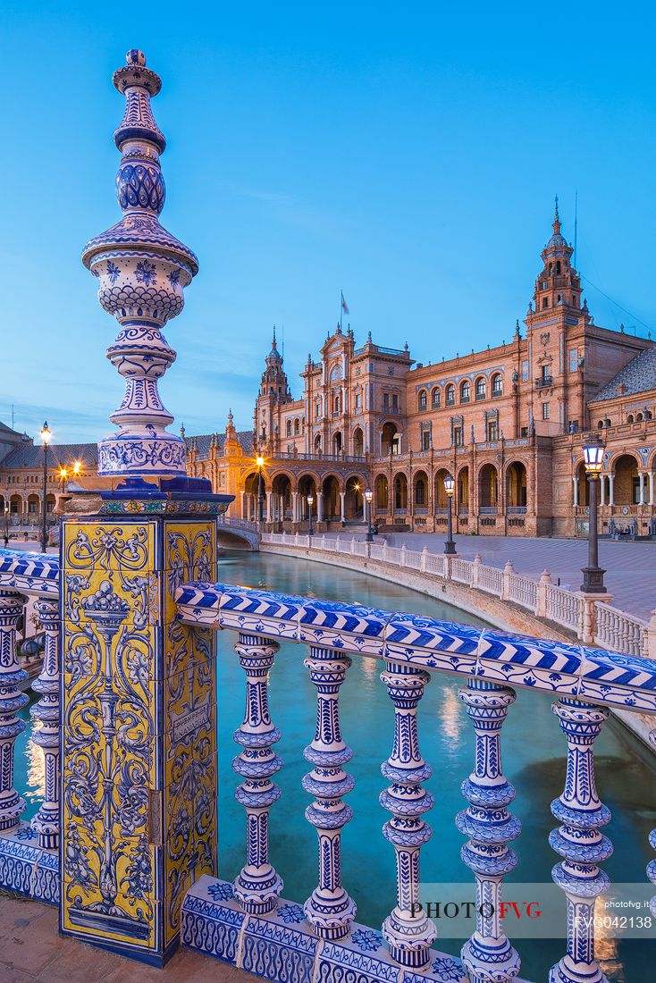 One of the four bridges with ceramic ornaments that crosses the Plaza de Espana canal at twilight, Seville, Andalusia, Spain, Europe