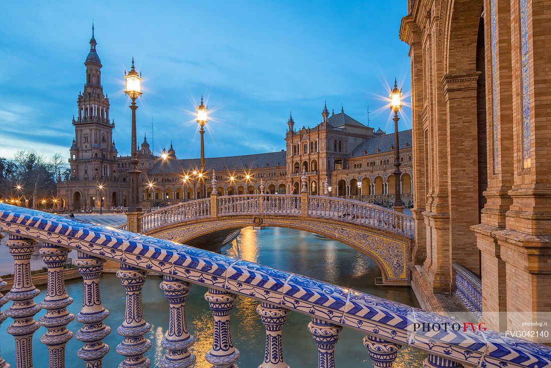 One of the four bridges with ceramic ornaments that crosses the Plaza de Espana canal at twilight, Seville, Andalusia, Spain, Europe