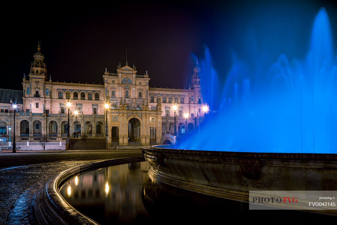 Fountain in the Plaza de Espana and in the background the government building by night, Seville, Andalusia, Spain, Europe