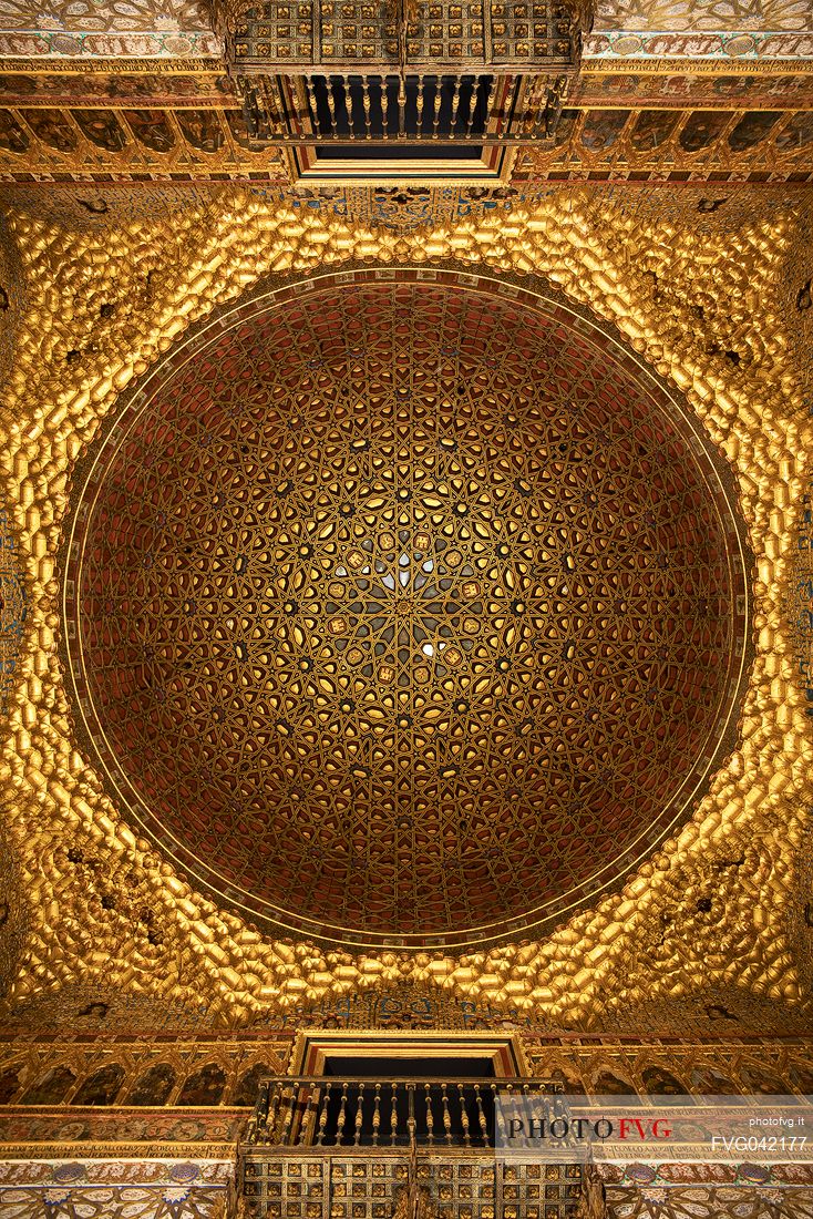 The dome of the Hall of Ambassadors, made of carved and gilded woven wood, in the Palace of the Real Alcazar, Seville, Andalusia, Spain, Europe The dome of the Hall of Ambassadors, made of carved and gilded woven wood, in the Palace of the Real Alcazar, Seville, Andalusia, Spain, Europe