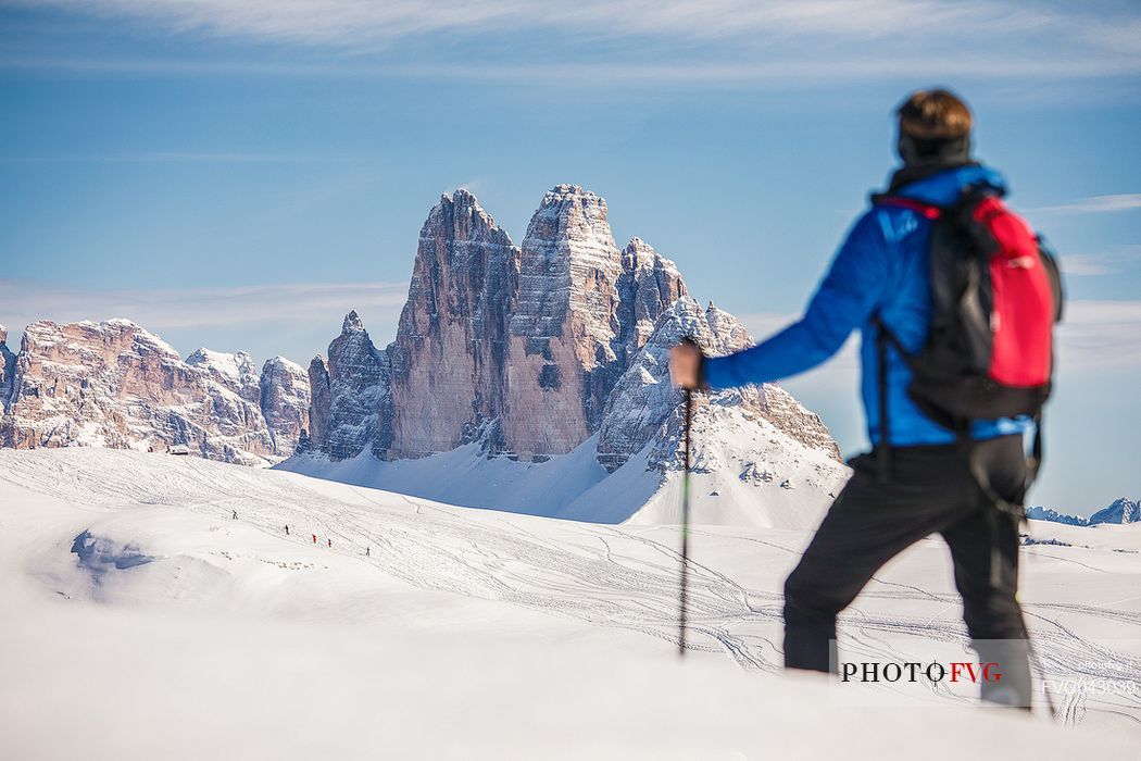 Hiker admires the Tre Cime di Lavaredo peak from Prato Piazza, Fanes Senes Braies Natural Park, Pustertal, dolomites, South Tyrol, Italy, Europe