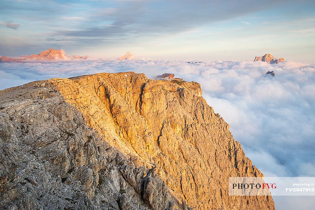 Panoramic view towards Lagazuoi refuge with Pelmo and Sorapiss peaks coming up from clouds, Cortina d'Ampezzo, dolomites, Veneto, Italy, Europe