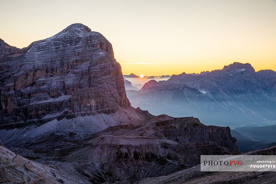 The sun rises behind Tofana di Rozes Mount, Cortina d'Ampezzo, dolomites, Veneto, Italy, Europe