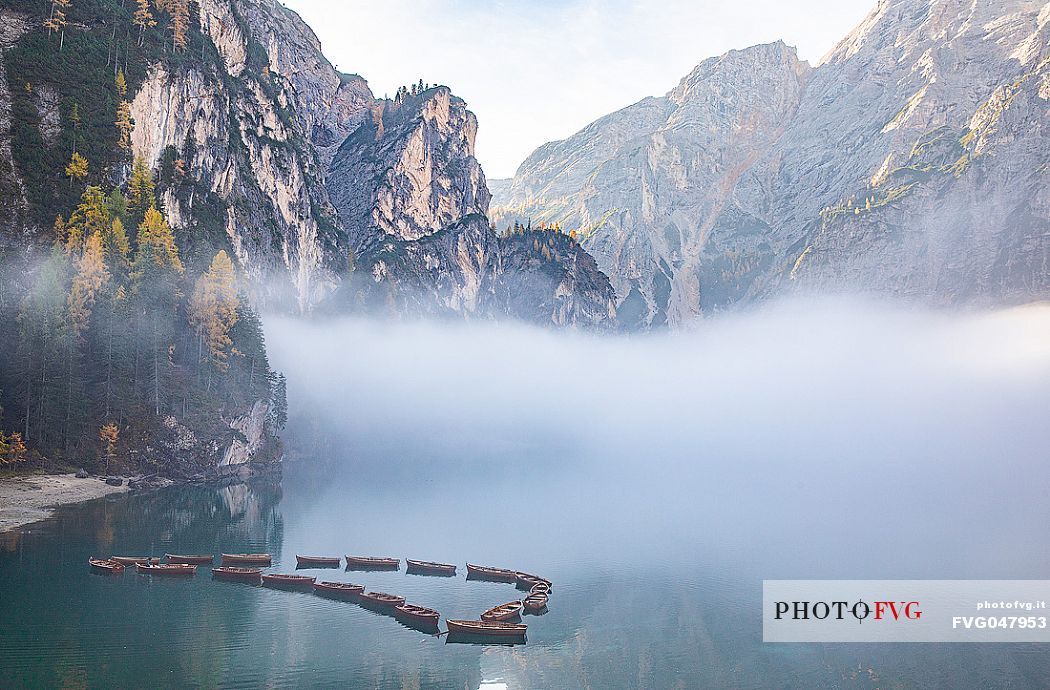 Moored boats in the lake of Braies in autumn, dolomites, Pusteria valley, Trentino Alto Adige, South Tyrol, Italy, Europe