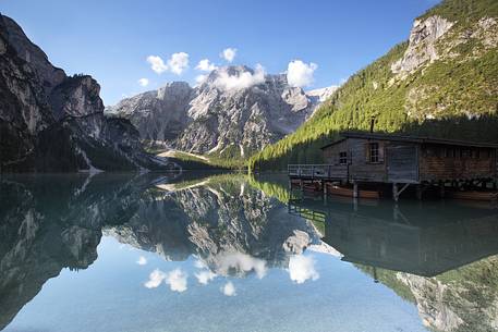 Hut on Braies lake and Croda del Becco in the background in a clear summer day