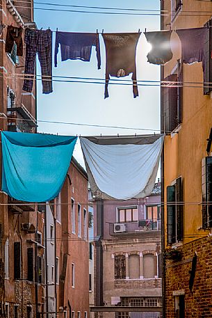 Traditional Venetian street with clothes hanging in the sun