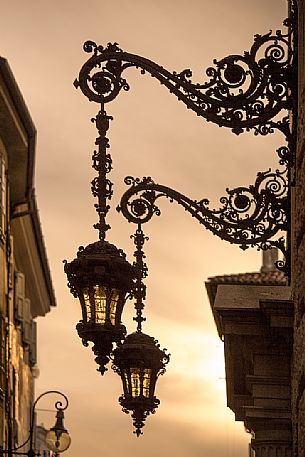 Street lights at sunset in the center of Udine