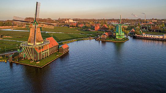 Zaanse Schans , the small community of 40 homes located north - east of Amsterdam , on the quay of the river Zaan , famous for its windmills