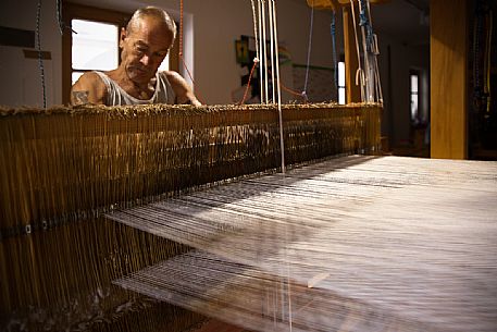 Hand weaver Herman Khebacher of Villabassa, the only one of South Tyrol using today still the traditional technique of weaving to handle and to use almost exclusively of natural fibers of wool and linen not treated with chemical products