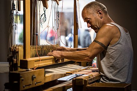 Hand weaver Herman Kühebacher of Villabassa, the only one of South Tyrol using today still the traditional technique of weaving to handle and to use almost exclusively of natural fibers of wool and linen not treated with chemical products Hand weaver Herman Kühebacher of Villabassa, the only one of South Tyrol using today still the traditional technique of weaving to handle and to use almost exclusively of natural fibers of wool and linen not treated with chemical products
