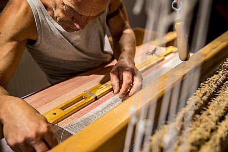 Hand weaver Herman Khebacher of Villabassa, the only one of South Tyrol using today still the traditional technique of weaving to handle and to use almost exclusively of natural fibers of wool and linen not treated with chemical products