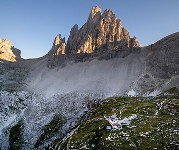 Aerial view of the alpine hut of Zsigmondy - Comici with the Croda dei Toni on background lit by sunset, Sexten dolomites, Tre Cime natural park, Dolomites, South Tyrol, Italy, Europe