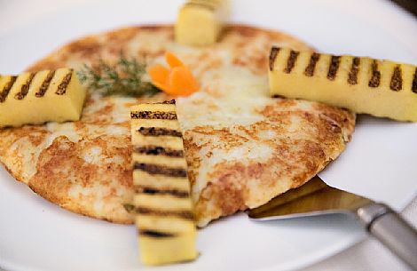 Frico with polenta, a typical dish from Friuli