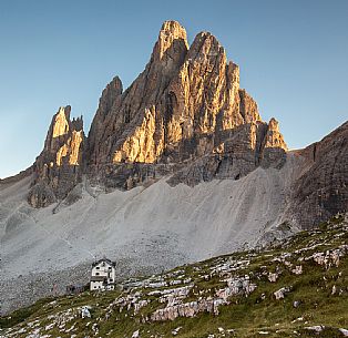 The alpine hut of Zsigmondy - Comici with the Croda dei Toni on background lit by sunset, Sexten dolomites, Tre Cime natural park, Dolomites, South Tyrol, Italy, Europe