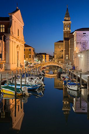 Blue hour on canal Vena with the church tower of Saint James on background, Chioggia, Venetian lagoon, Italy