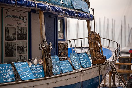Picturesque venetian boat in the harbor of Chioggia, venetian lagoon, Italy