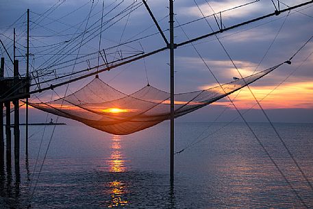Fishing net on the beach at dawn, Sottomarina, Chioggia, venetian lagoon, Italy Fishing net on the beach at dawn, Sottomarina, Chioggia, venetian lagoon, Italy