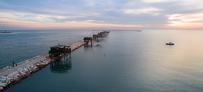 Stilt fishermen on the sea at the dam of Sottomarina, Chioggia, venetian lagoon, Italy